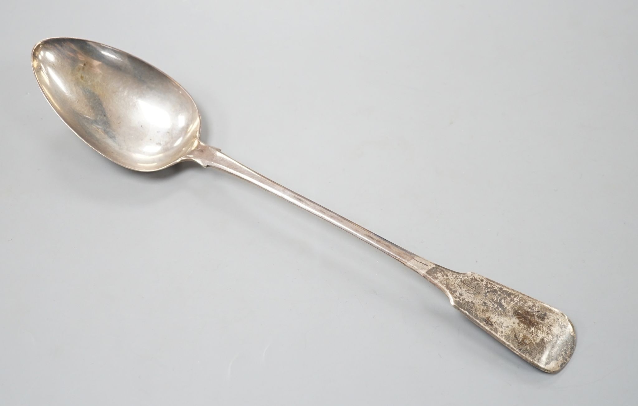 A George III silver fiddle pattern basting spoon, William Seaman, London, 1816, 31.5cm, 109 grams.